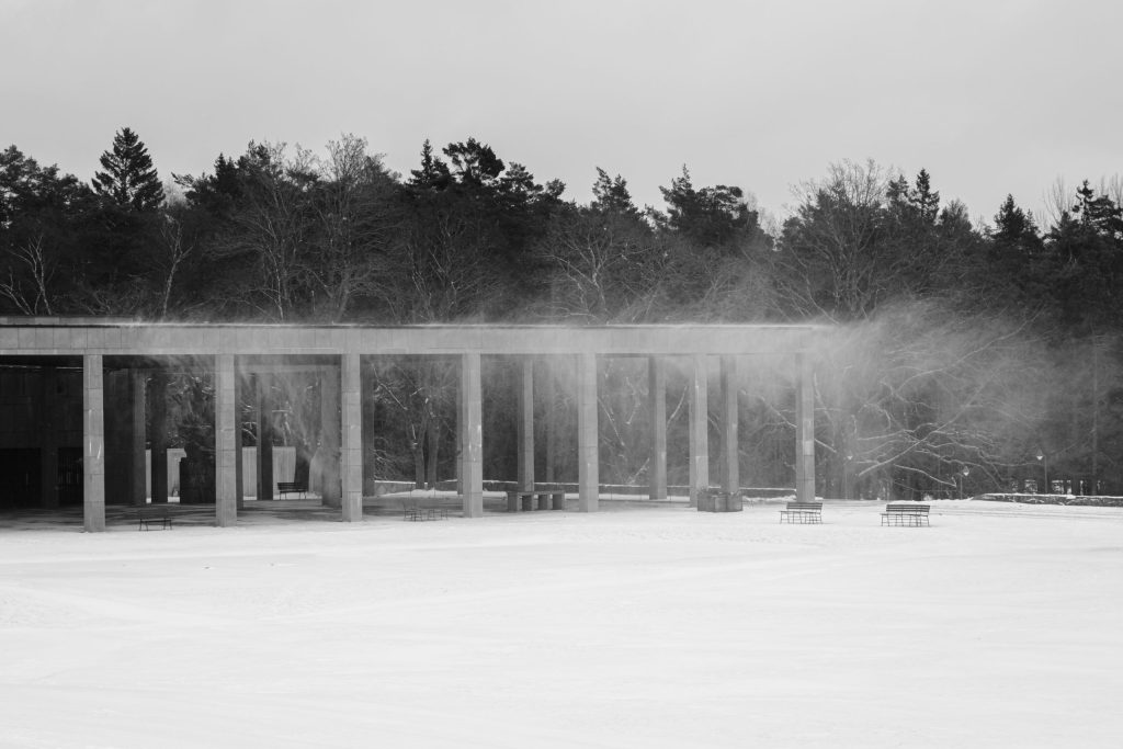 Blowing Snow Black and white image of snow blowing off the roof of a stone building