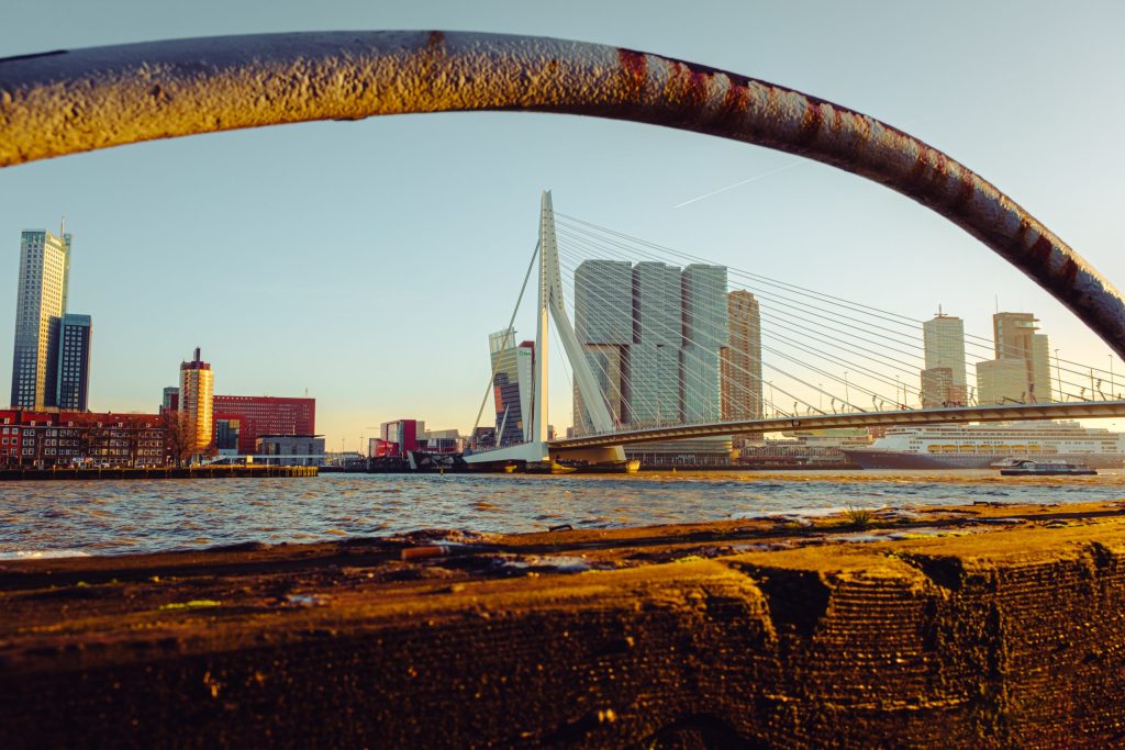 Rotterdam Waterfront A bridge and buildings in Rotterdam, seen through a metal arch