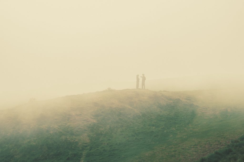 Hikers in the Fog Two hikers barely visible through the fog
