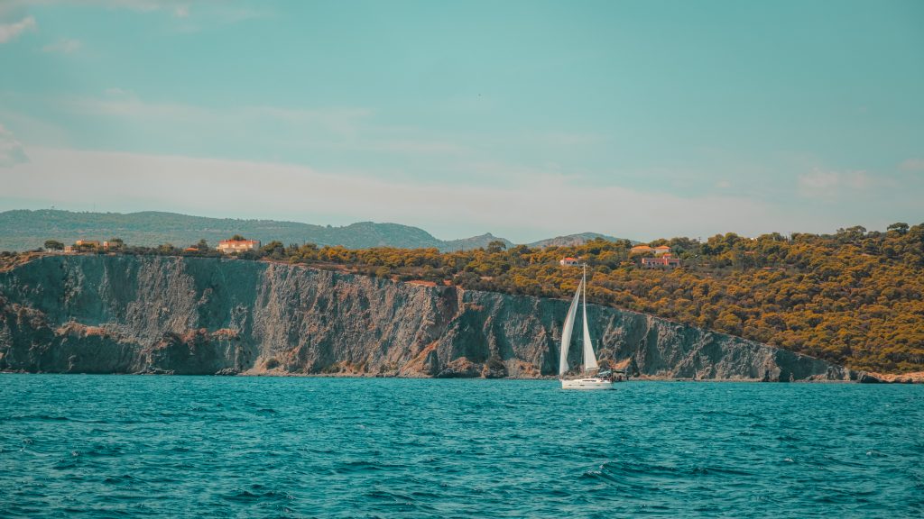 Sailboat and Cliffs A sailboat sailing near cliffs