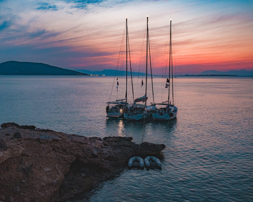 Sailboats at Sunset Three sailboats and two small dinghies anchored near shore