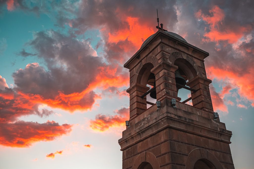 Bell Tower A stone bell tower against a firey sky at sunset