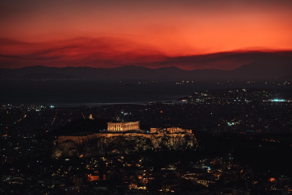 Acropolis at Twilight The Acropolis during twilight, with the city of Athens, boats, and mountains visible behind it.